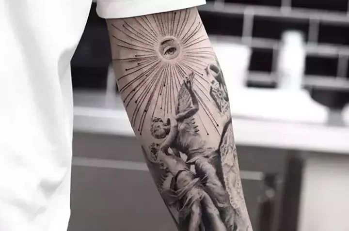 Black and grey forearm tattoo with a classical figure and radiating lines