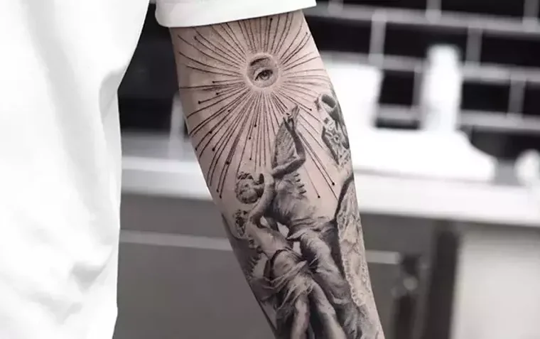 Black and grey forearm tattoo with a classical figure and radiating lines