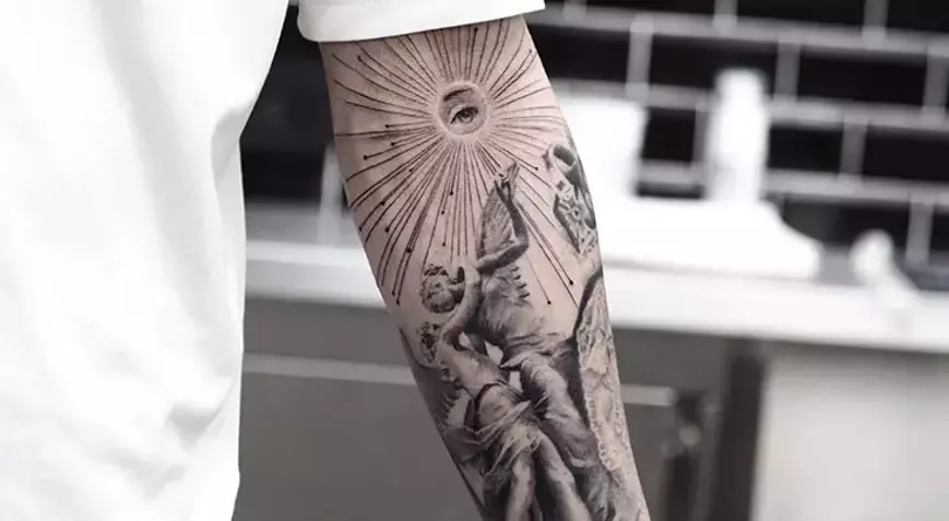 Black and grey forearm tattoo with a classical figure and radiating lines