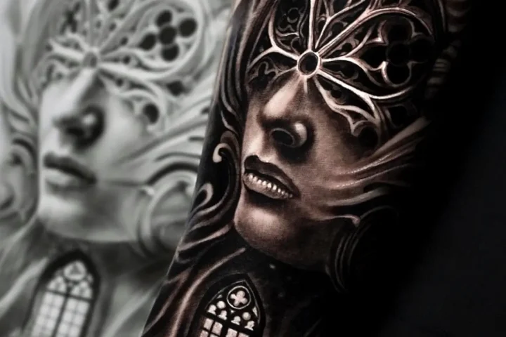 Black and grey realistic portrait tattoo with ornate Gothic window details