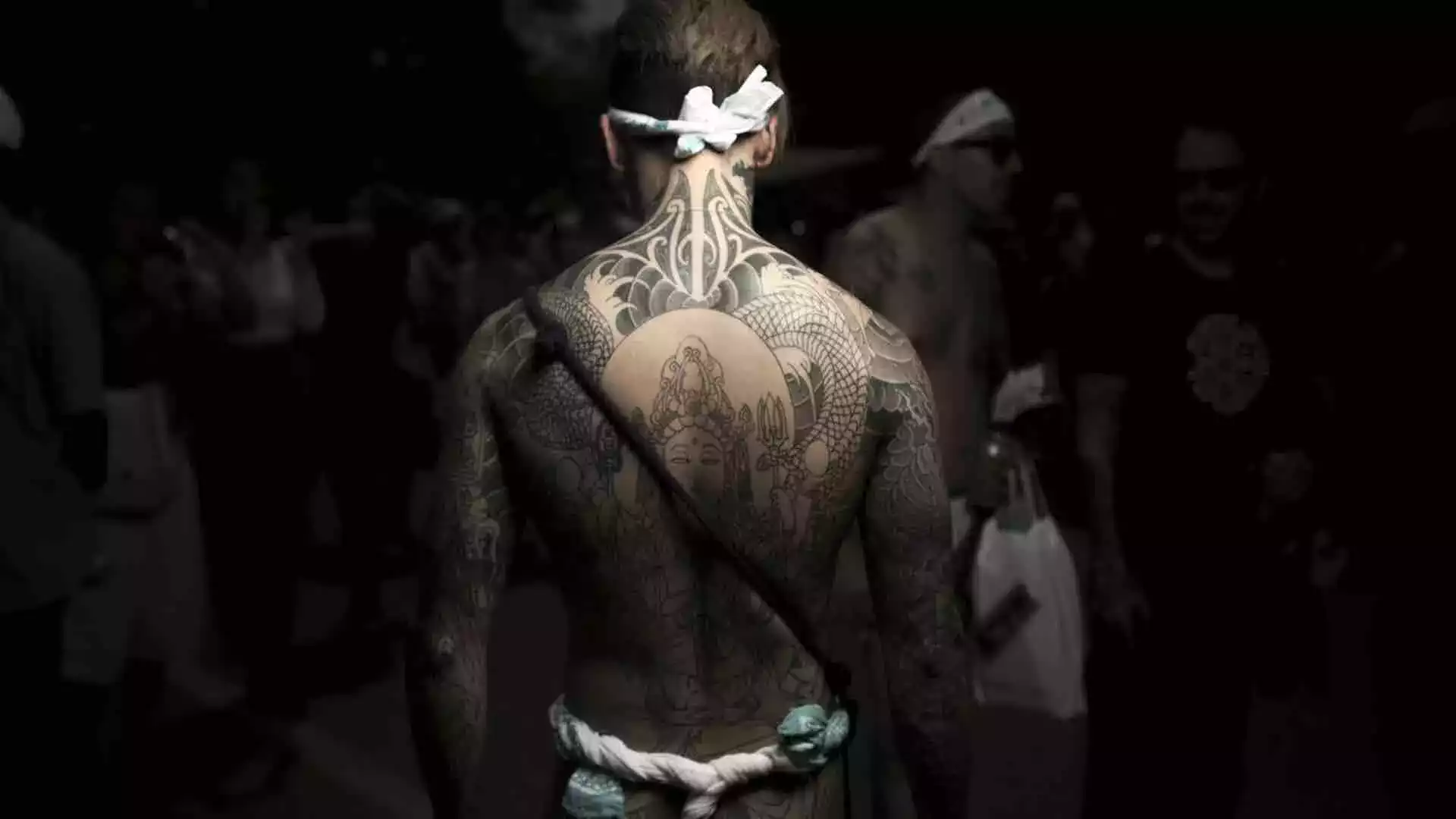 Large back tattoo featuring a central figure surrounded by detailed patterns